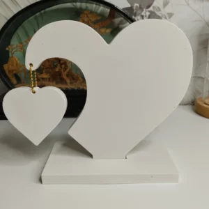 Décoration en forme de cœur blanc avec petit cœur suspendu, design élégant.