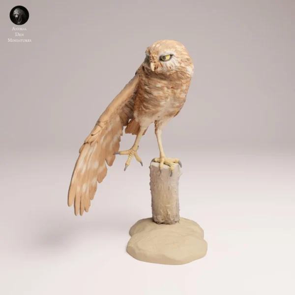 figurine-chouette-resine-peinture Une figurine chouette en résine à peindre, posée délicatement sur une table en bois, montrant l'oiseau de profil en train d'étirer ses ailes avec douceur.