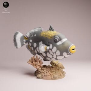 Vue de profil de la figurine poisson baliste clown à peindre, montrant avec précision les détails fins des nageoires sur son socle texturé.