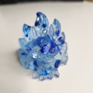 Figurine miniature de Kitsune en résine bleu saphir avec ses neuf queues déployées, vue de face.