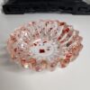 vide-poche-rond-floral-resine-rouge Élégant vide-poche rond au design floral en résine transparente incrusté d'éclats rouge rubis.