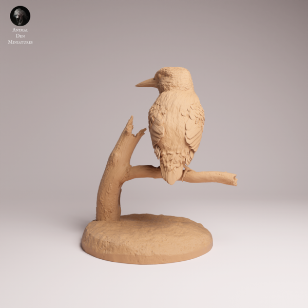 Focus sur le socle circulaire et la branche texturée imitation écorce de la figurine en résine Pamkycréa.