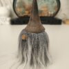 detail-chapeau-ebonise-fissure Gros plan sur le chapeau d'une figurine lutin des forêts rustique. Le bois est traité par ébonisation, révélant une teinte noire profonde traversée par une fine fissure verticale très esthétique.